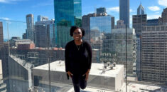 Ro'Shunda on the RIU Plaza Chicago rooftop with the Chicago skyline behind her