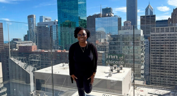 Ro'Shunda on the RIU Plaza Chicago rooftop with the Chicago skyline behind her