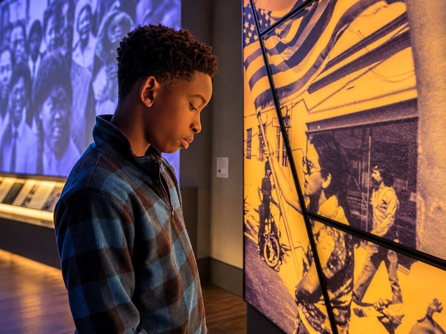 Young visitor looking at exhibits inside the Obama Presidential Center museum