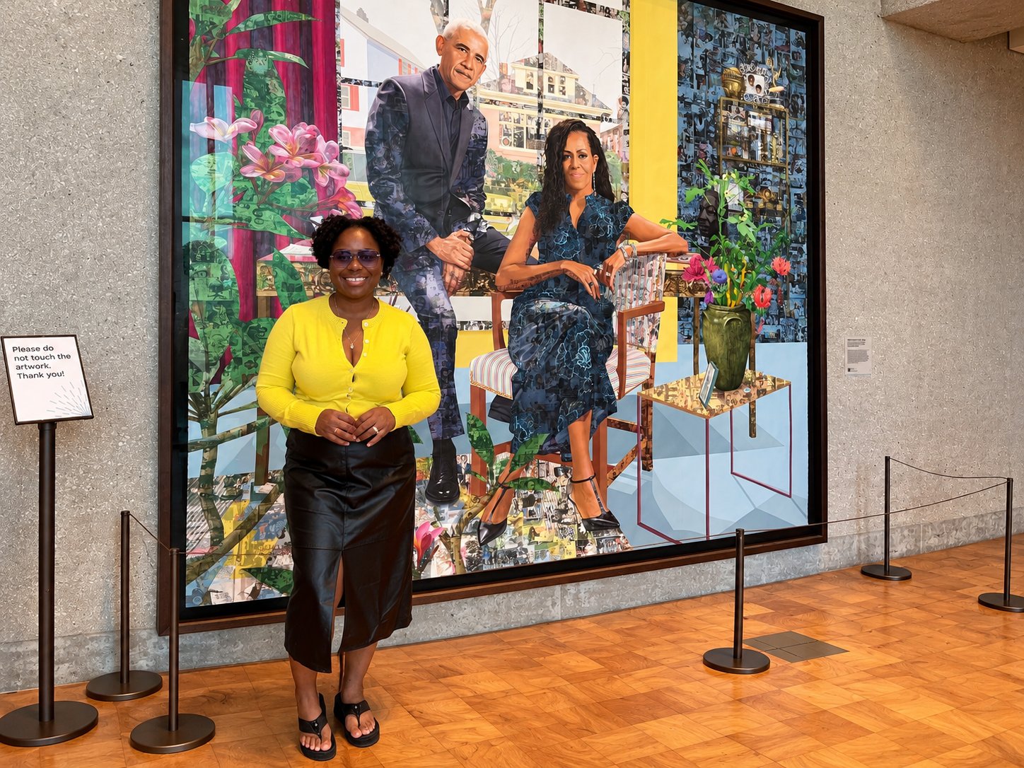 Ro'Shunda standing in front of the Obama presidential portrait at the Obama Presidential Center